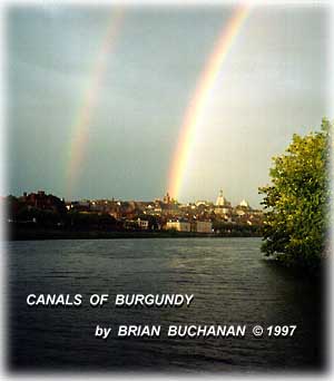 double rainbows over French town in distance